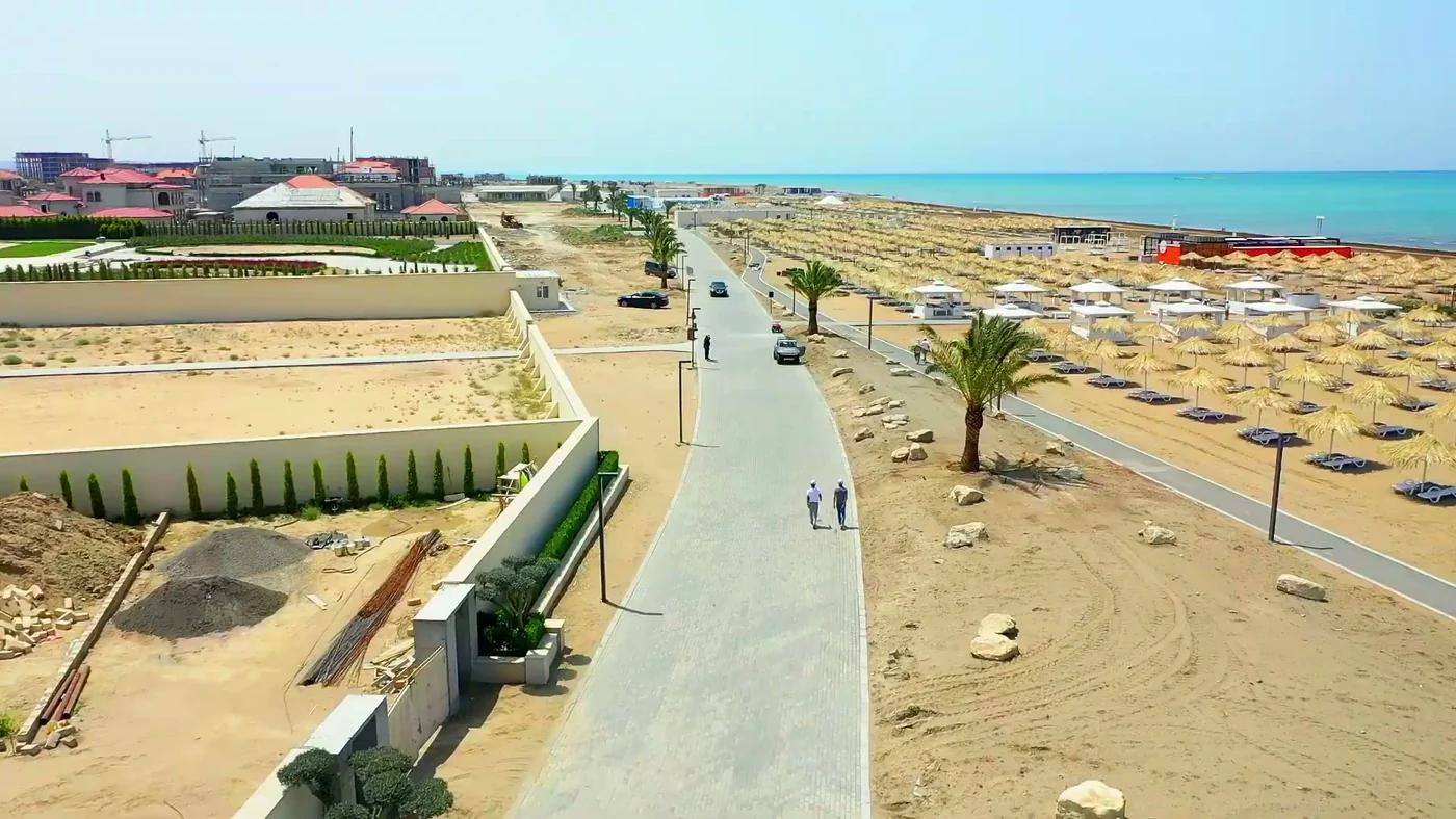 A path along the beach and a row of umbrellas